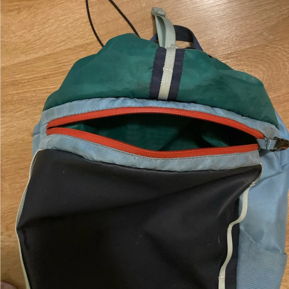 cotopaxi navy blue light blue green striped backpack